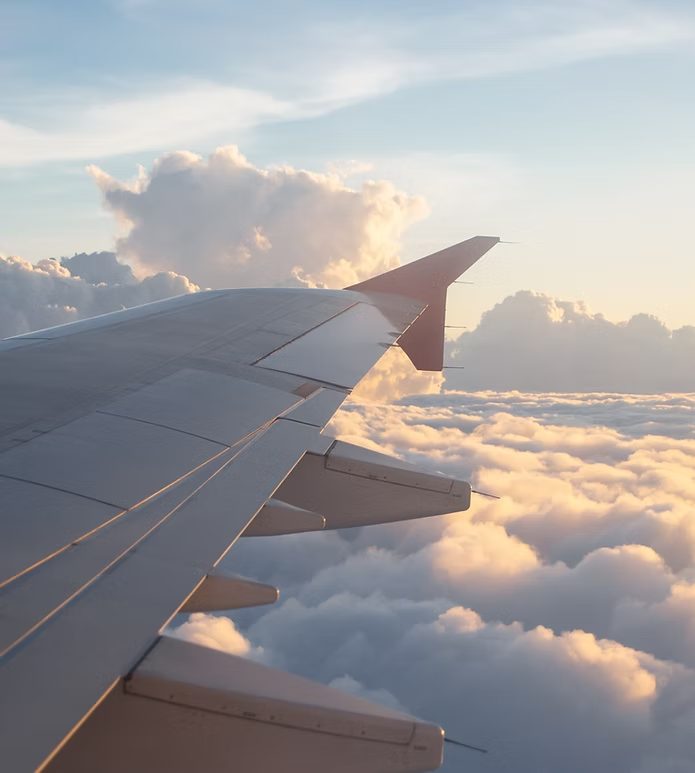View over an aeroplane wing above the clouds